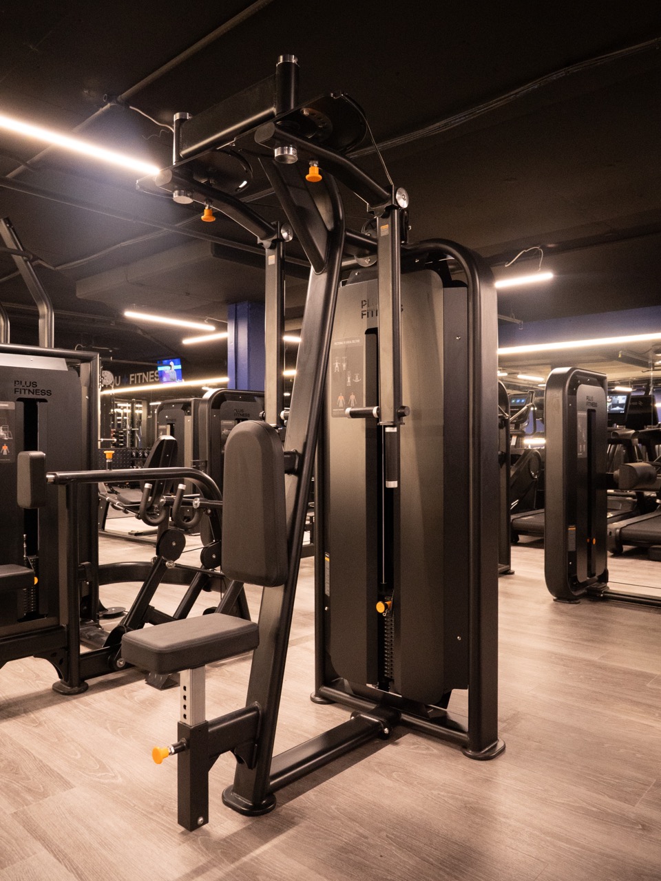 Pin-loaded strength floor overview — SHUA machines with Plus Fitness branding